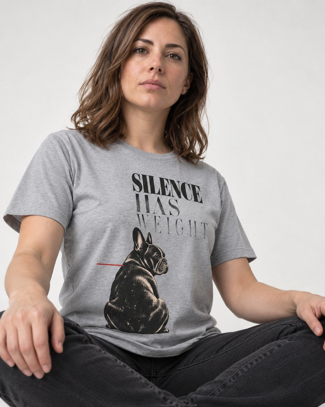 Silence Has Weight Frenchie T-Shirt in Sport Grey, worn by a seated model