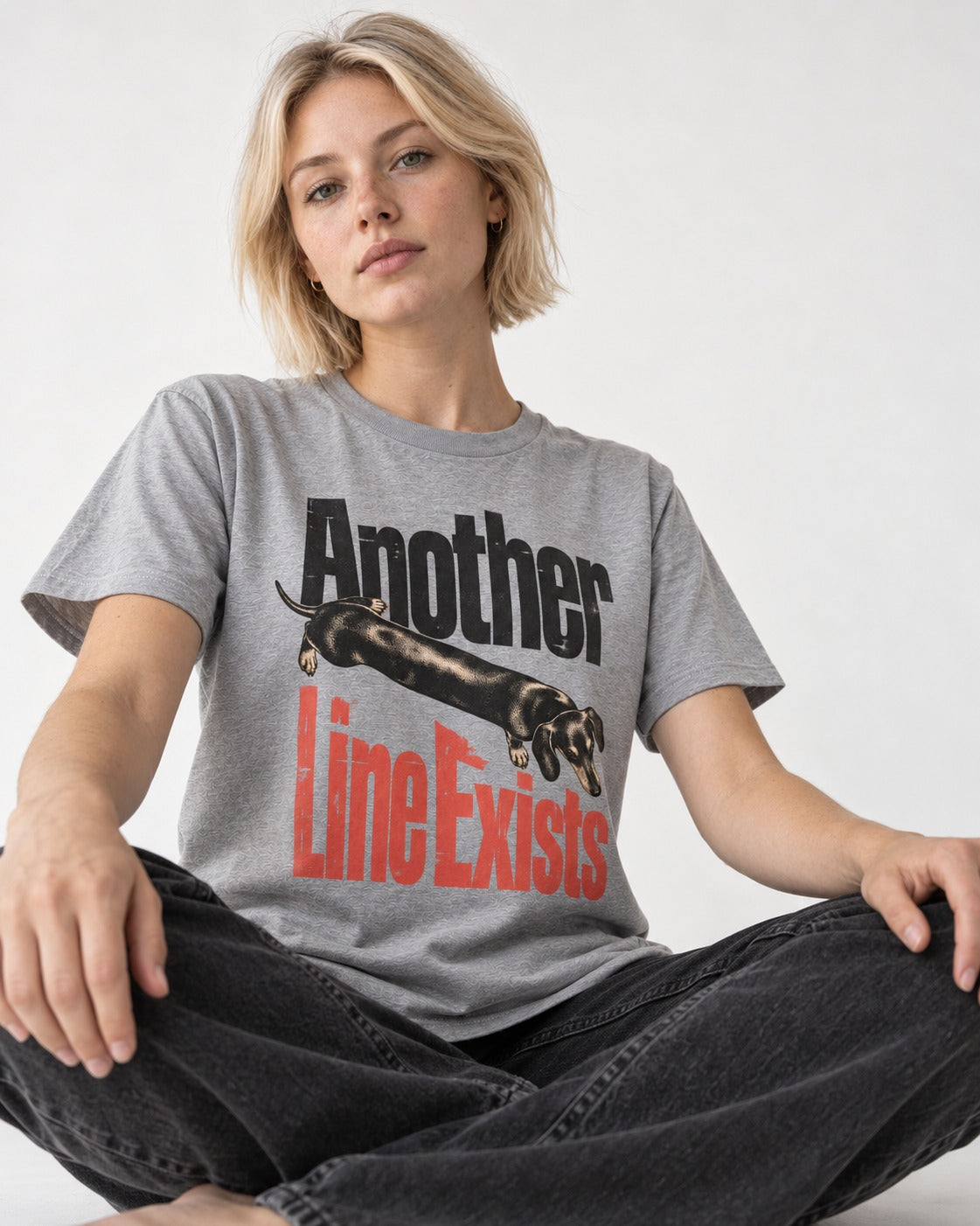 Another Dachshund Line Exists T-Shirt in Sport Grey, worn by a seated model