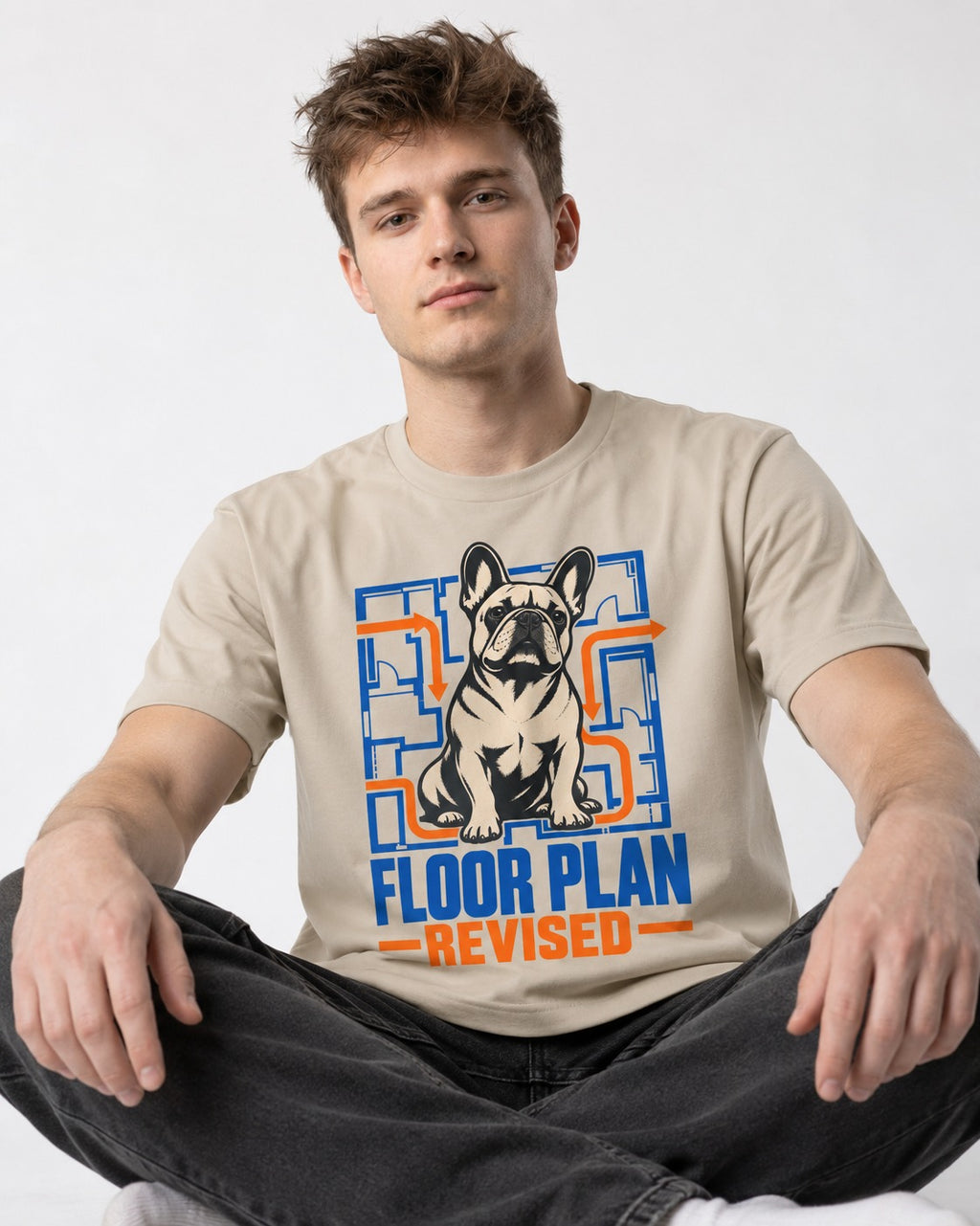 Frenchie Floor Plan Revised T-Shirt in Sand, worn by a seated model