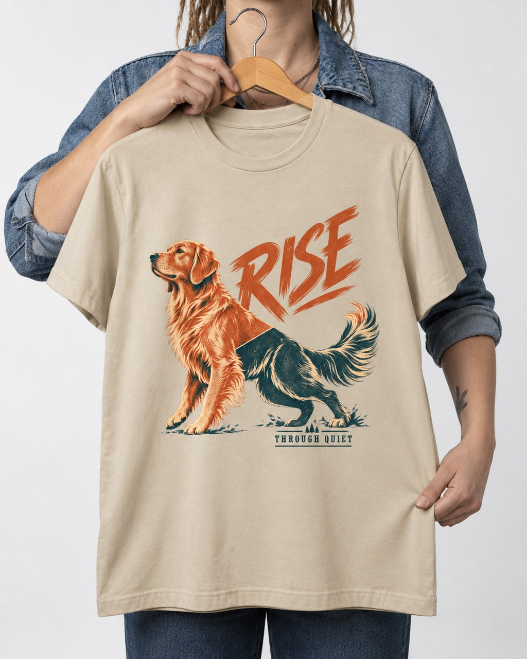 Golden Retriever Rise Through Quiet T-Shirt in Sand, held up on a hanger