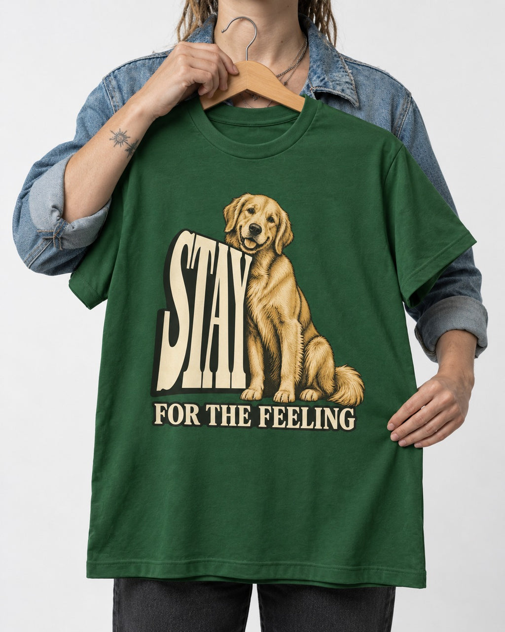 Golden Retriever Stay for the Feeling Leaning Puppy Graphic T-Shirt in Forest Green, held up on a hanger