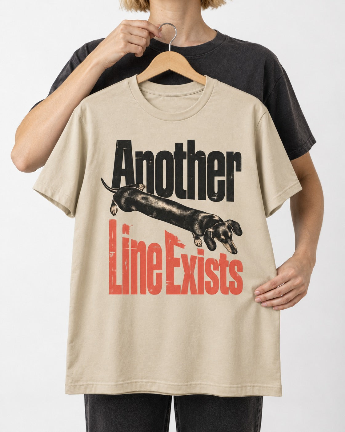Another Dachshund Line Exists T-Shirt in Sand, held up on a hanger