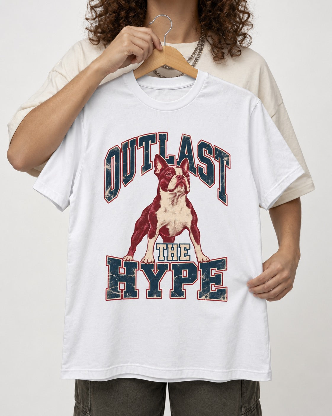 Boston Terrier Outlast The Hype Collegiate Graphic T-Shirt in White, held up on a hanger