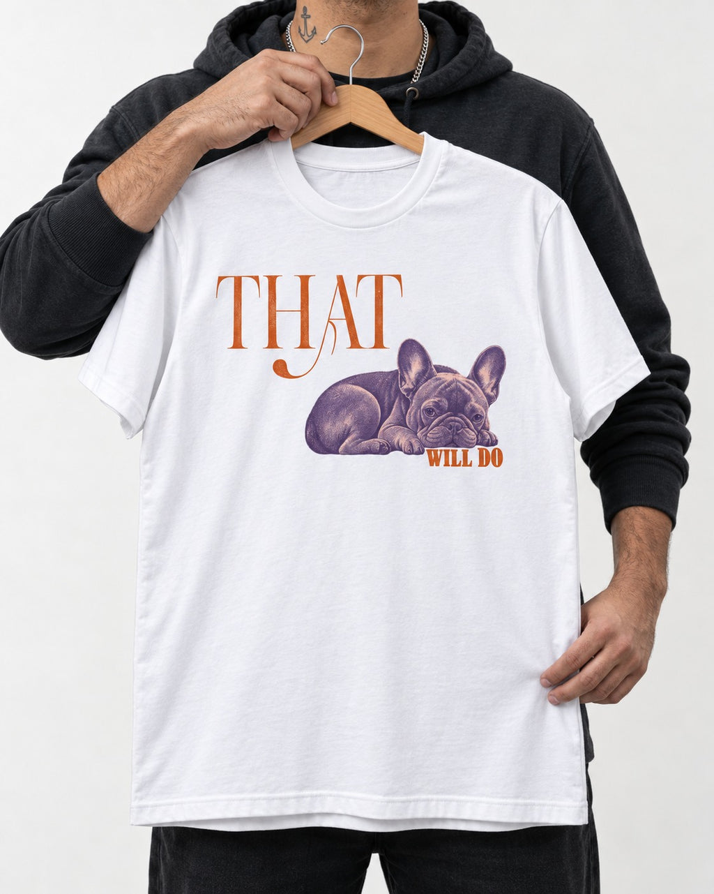 Frenchie That Will Do Resting Graphic T-Shirt in White, held up on a hanger