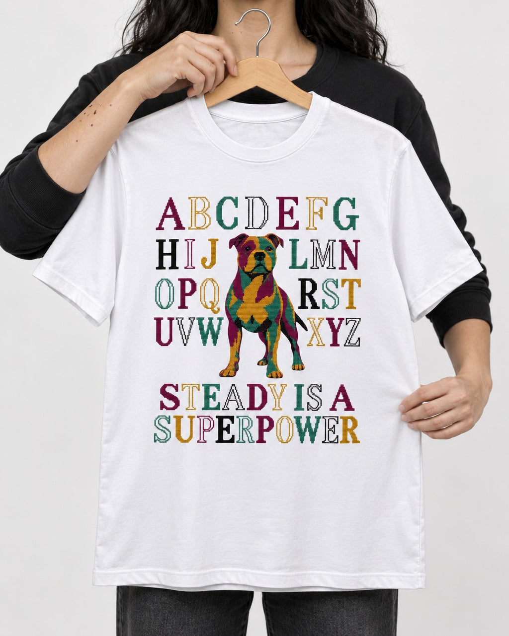 Pitbull Steady Is a Superpower Alphabet Graphic T-Shirt in White, held up on a hanger
