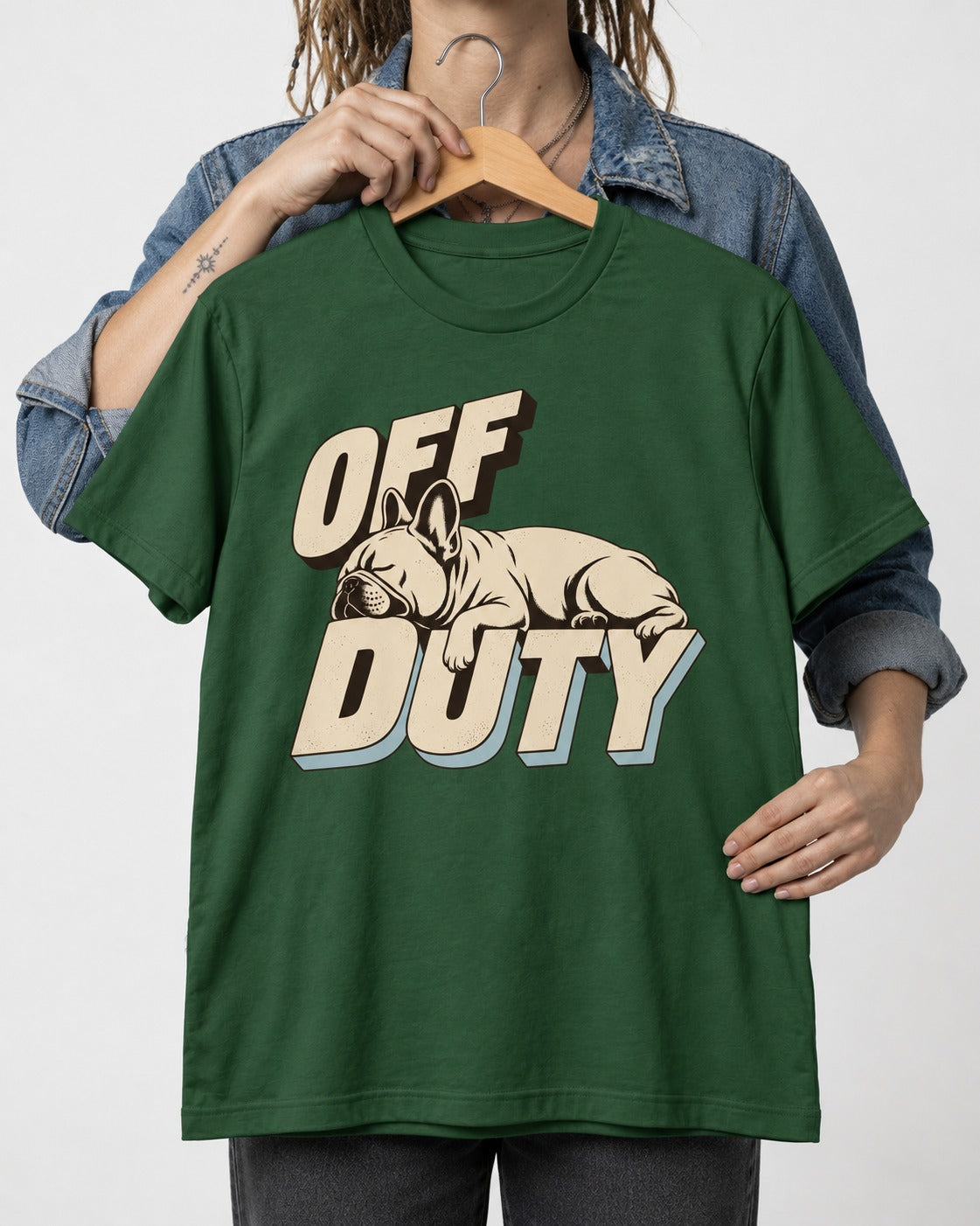 Frenchie Off Duty Sleeping Type Graphic T-Shirt in Forest Green, held up on a hanger