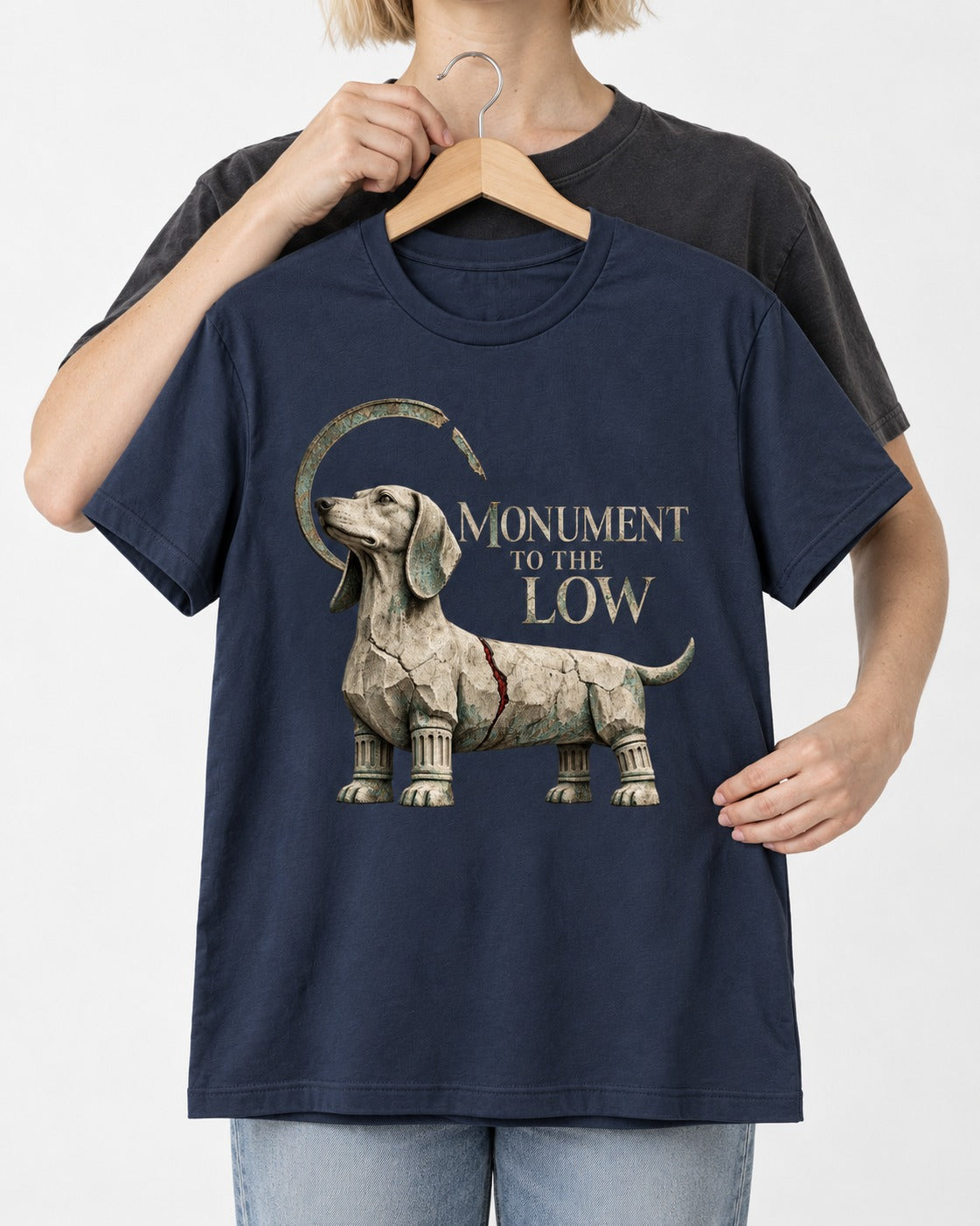 Dachshund Monument to the Low Stone Statue Graphic T-Shirt in Navy, held up on a hanger