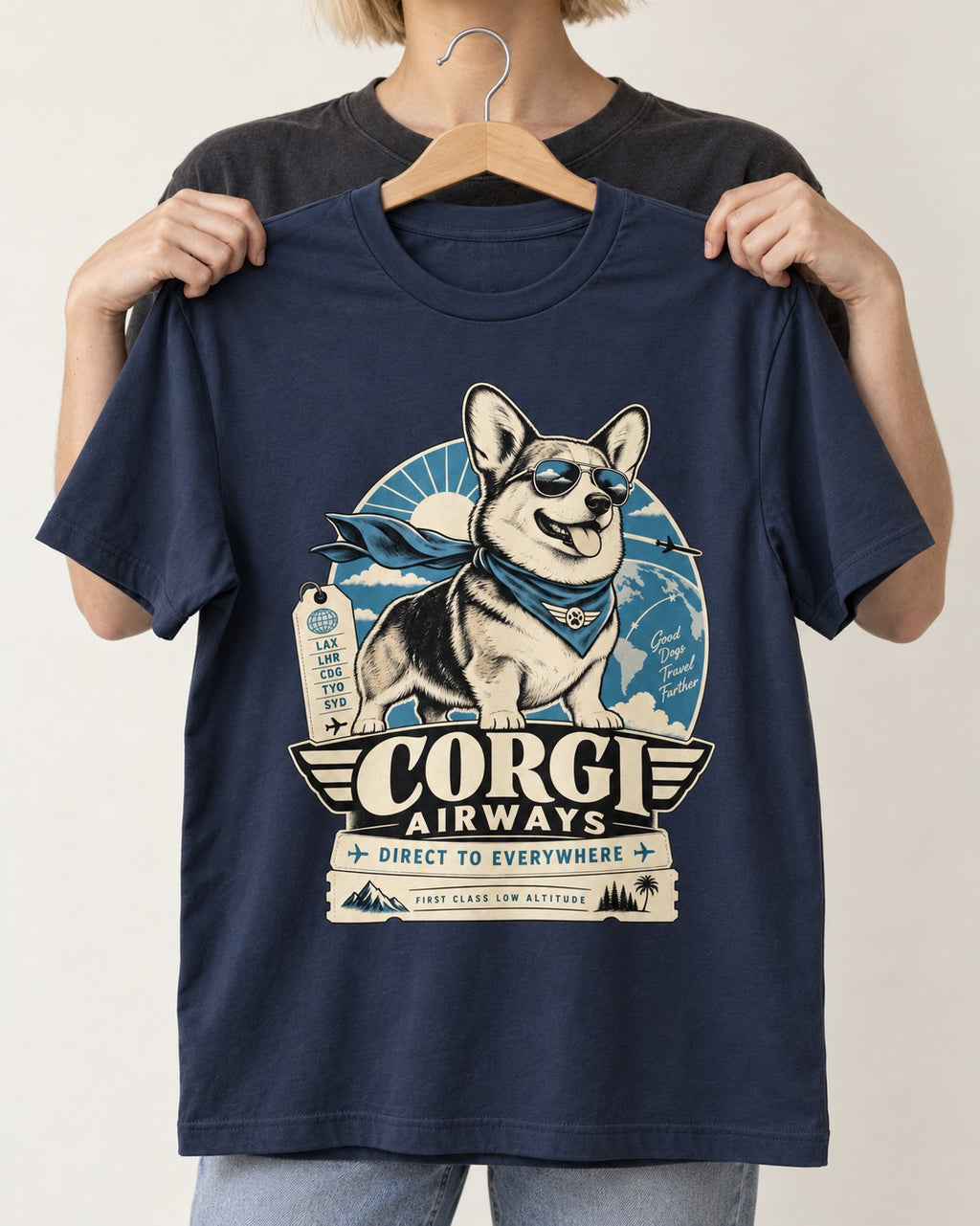 Corgi Airways Direct to Everywhere Badge T-Shirt in Navy, held up on a hanger
