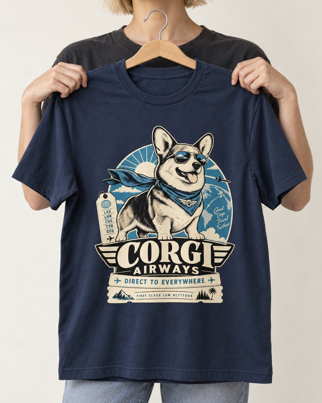 Corgi Airways Direct to Everywhere Badge T-Shirt in Navy, held up on a hanger