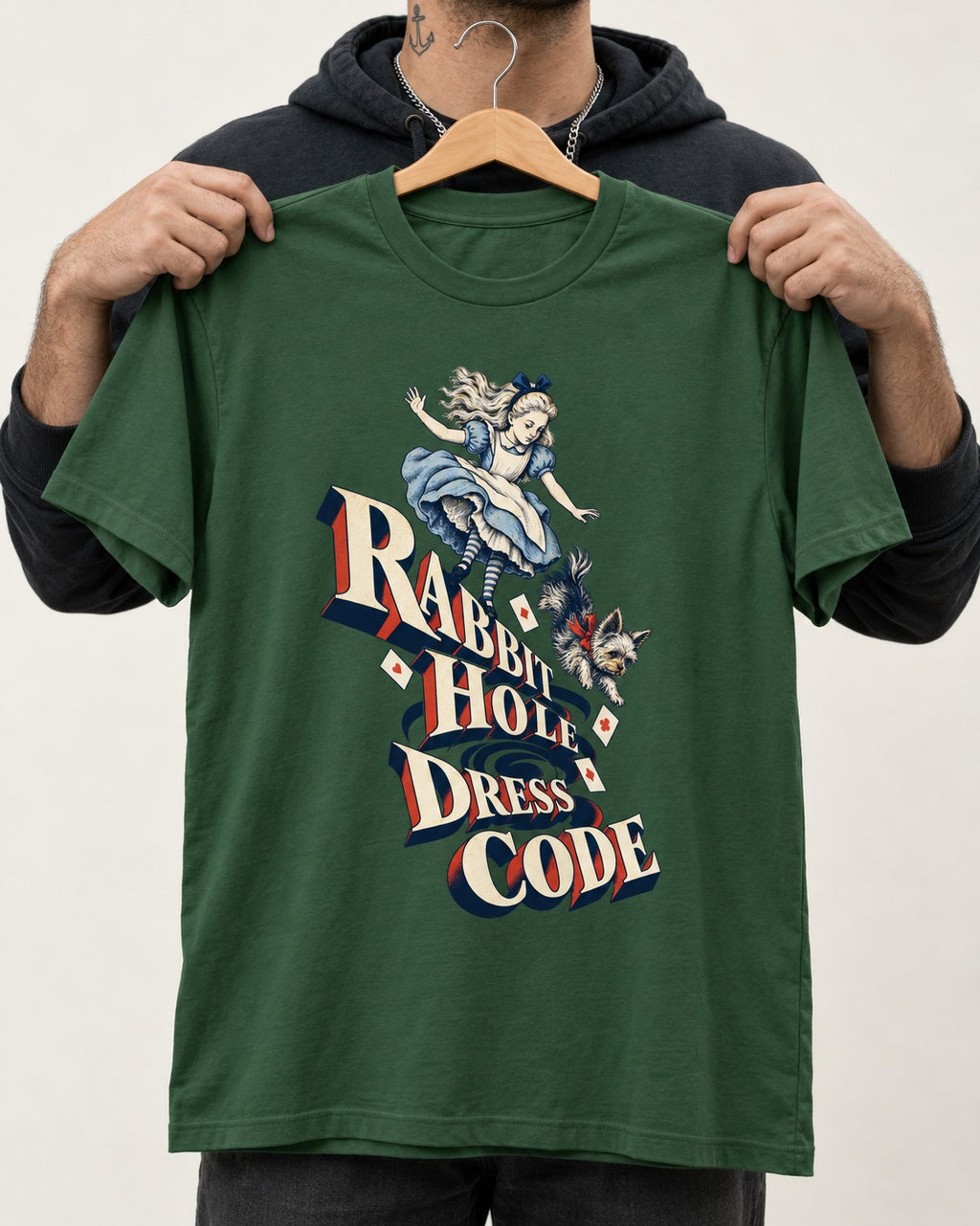 Yorkshire Terrier Rabbit Hole Dress Code Wonderland Graphic T-Shirt in Forest Green, held up on a hanger