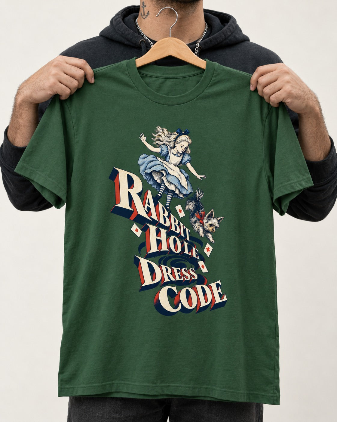 Yorkshire Terrier Rabbit Hole Dress Code Wonderland Graphic T-Shirt in Forest Green, held up on a hanger