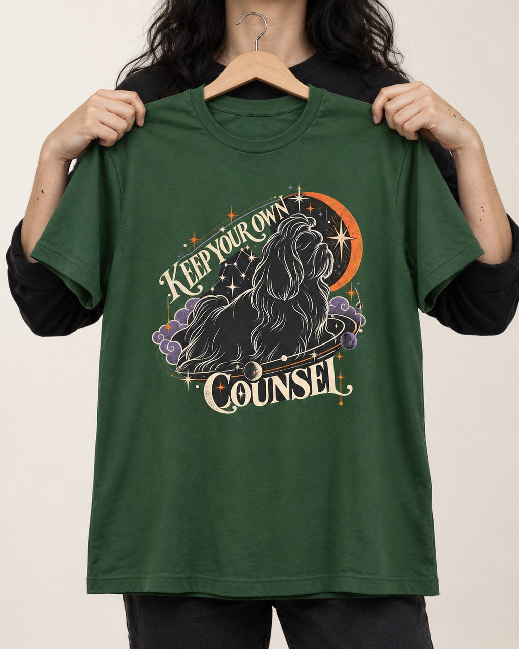 Shih Tzu Keep Your Own Counsel Celestial Graphic T-Shirt in Forest Green, held up on a hanger