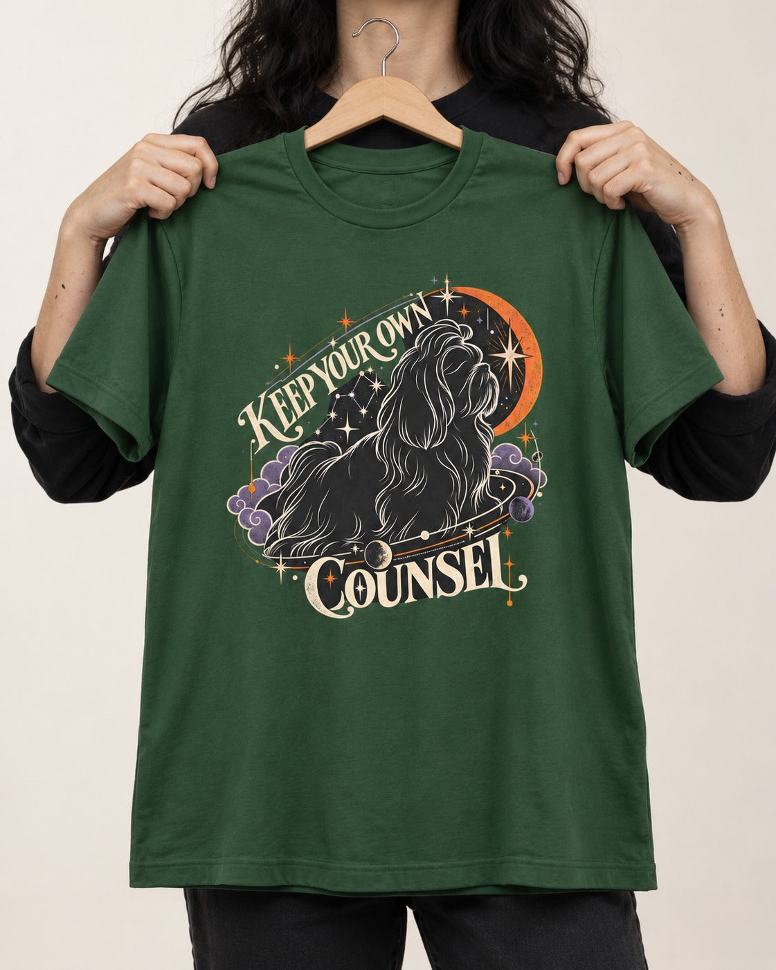 Shih Tzu Keep Your Own Counsel Celestial Graphic T-Shirt in Forest Green, held up on a hanger