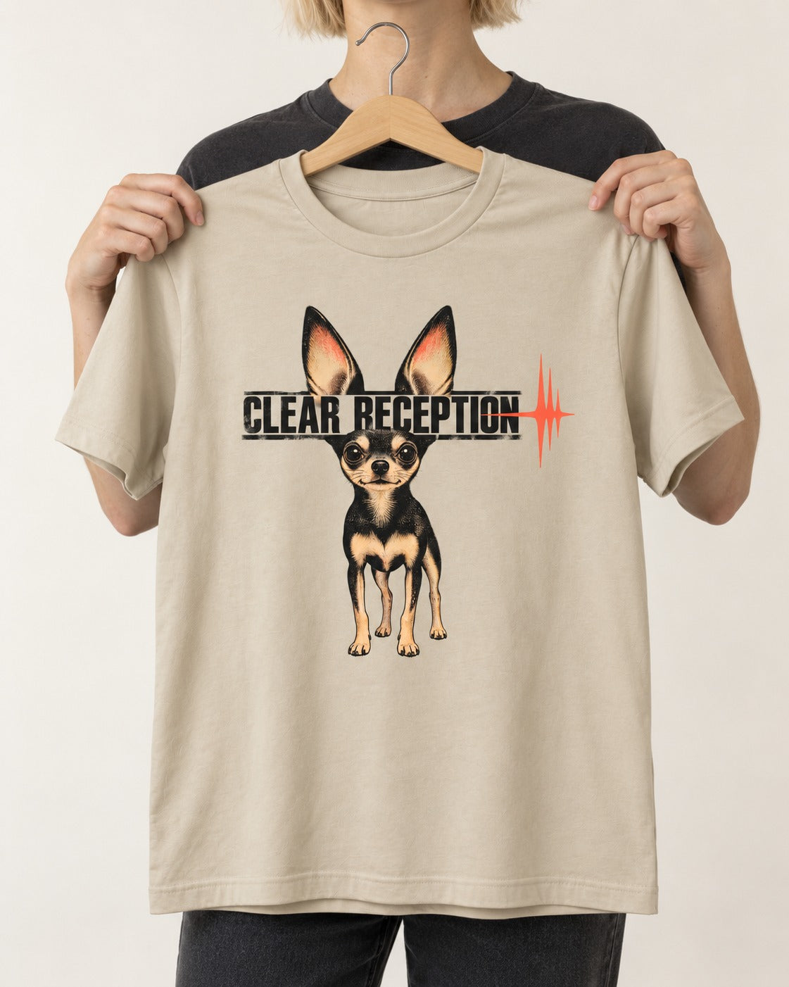 Chihuahua Clear Reception T-Shirt in Sand, held up on a hanger