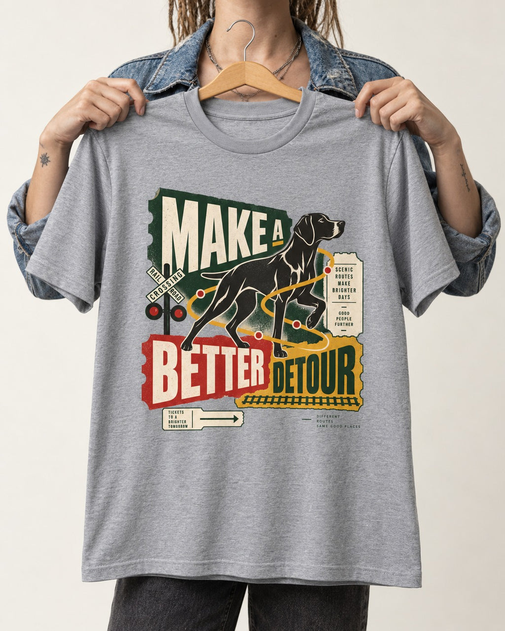 German Shorthaired Pointer Make a Better Detour Railroad Graphic T-Shirt in Sport Grey, held up on a hanger