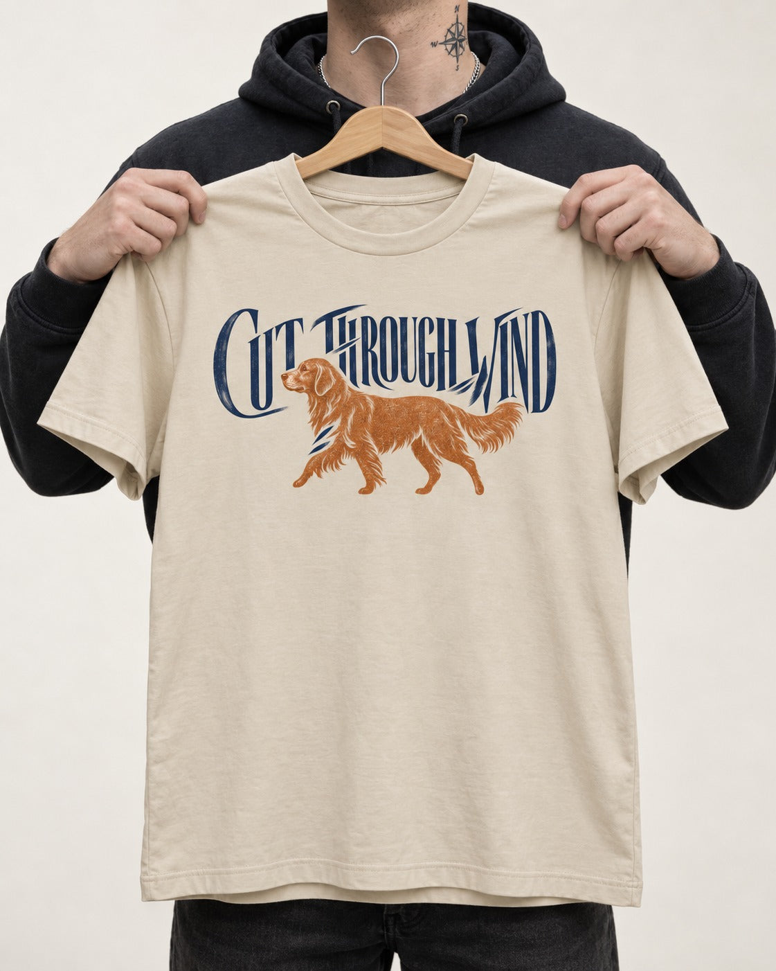 Golden Retriever Cut Through Land T-Shirt in Sand, held up on a hanger