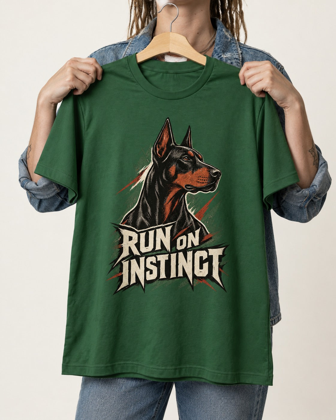 Doberman Run on Instinct Brush Slash Graphic T-Shirt in Forest Green, held up on a hanger
