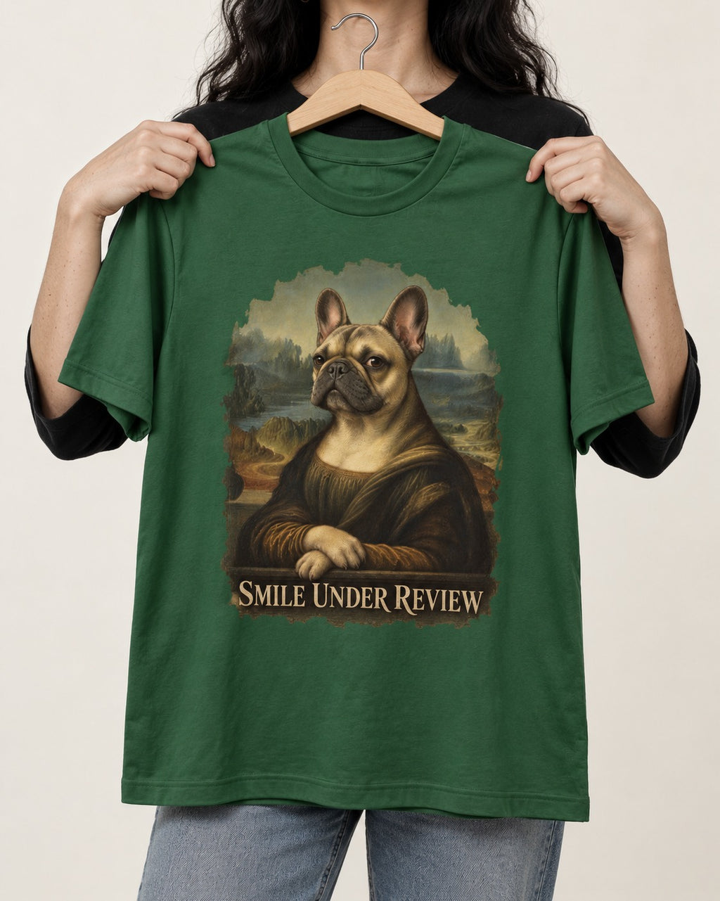 Frenchie Smile Under Review Renaissance Portrait T-Shirt in Forest Green, held up on a hanger