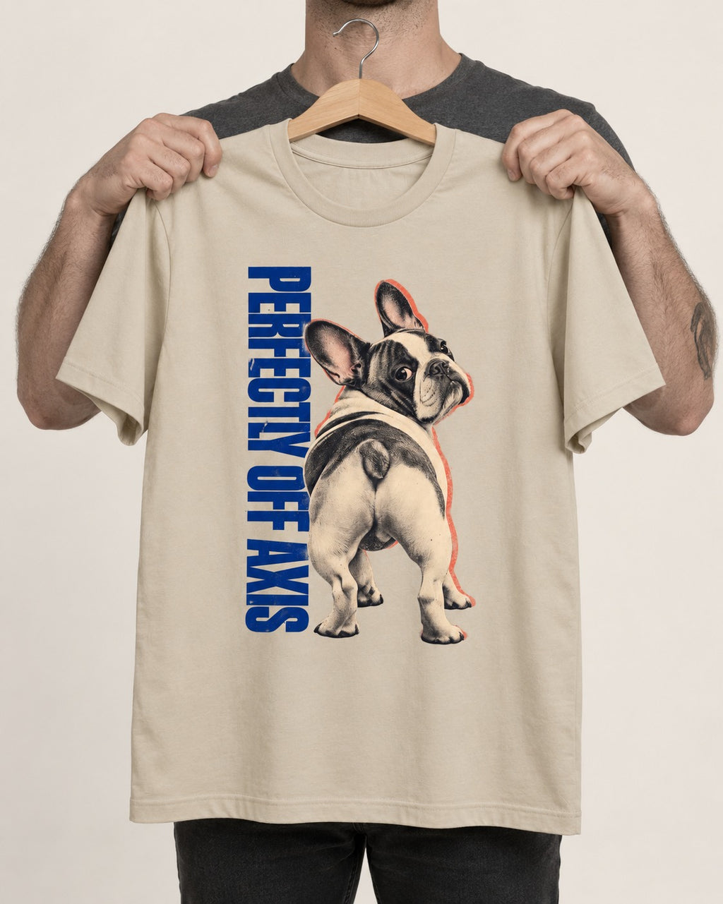 Perfectly Off Axis Frenchie T-Shirt in Sand, held up on a hanger