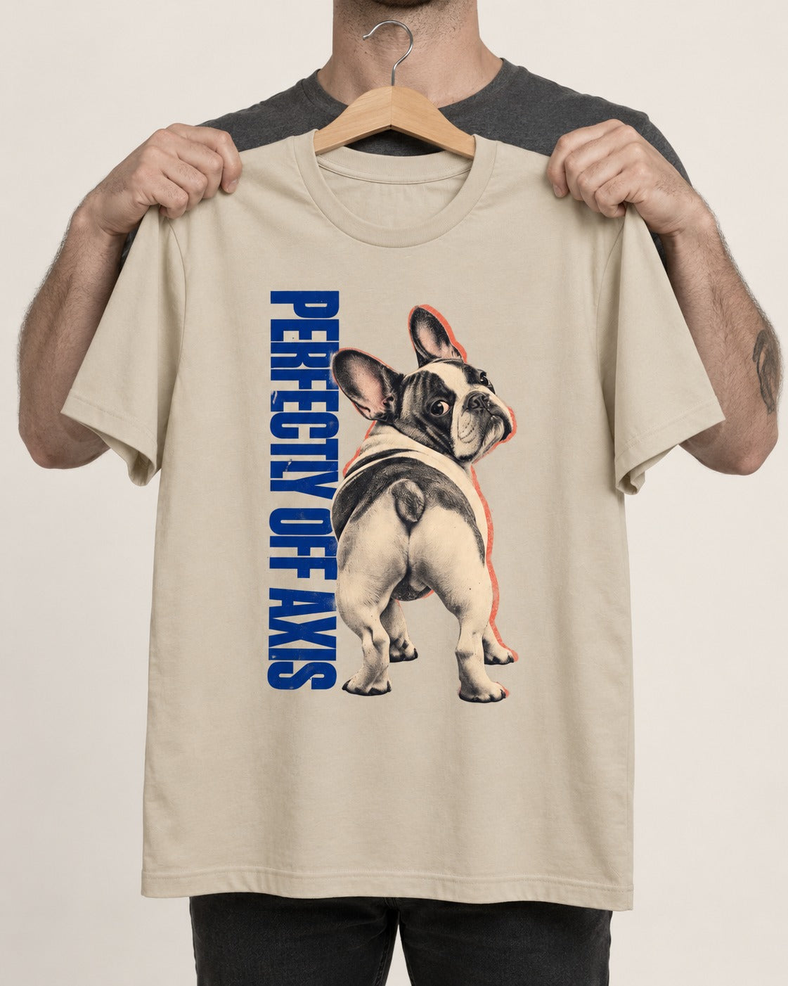 Perfectly Off Axis Frenchie T-Shirt in Sand, held up on a hanger