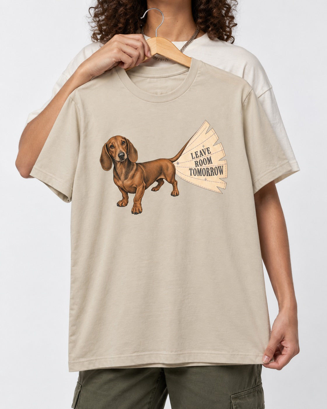 Dachshund Leave Room Tomorrow T-Shirt in Sand, held up on a hanger