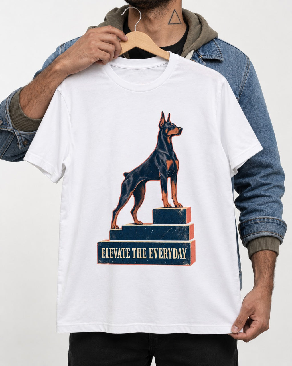 Doberman Elevate the Everyday Podium Graphic T-Shirt in White, held up on a hanger