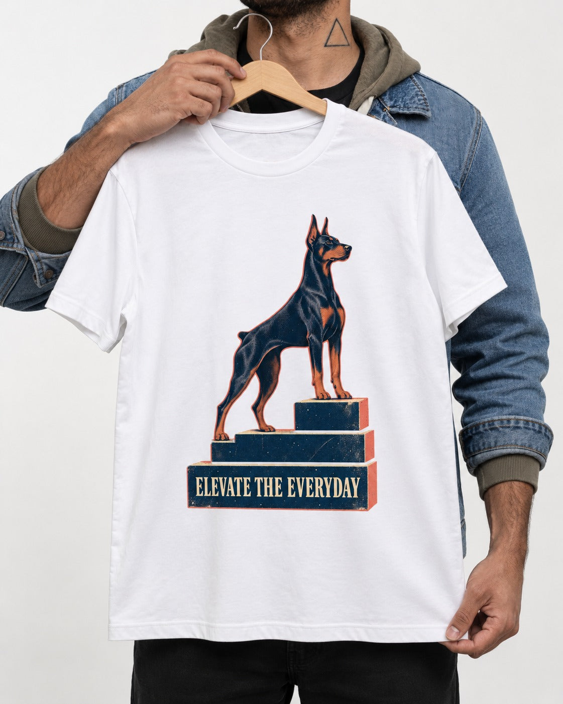 Doberman Elevate the Everyday Podium Graphic T-Shirt in White, held up on a hanger