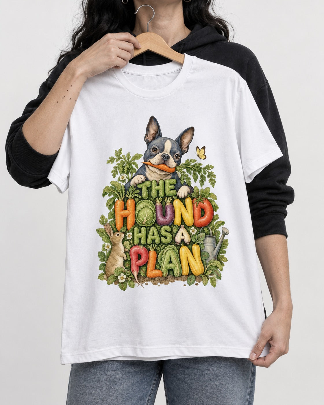 The Hound Has a Plan Boston Terrier T-Shirt in White, held up on a hanger