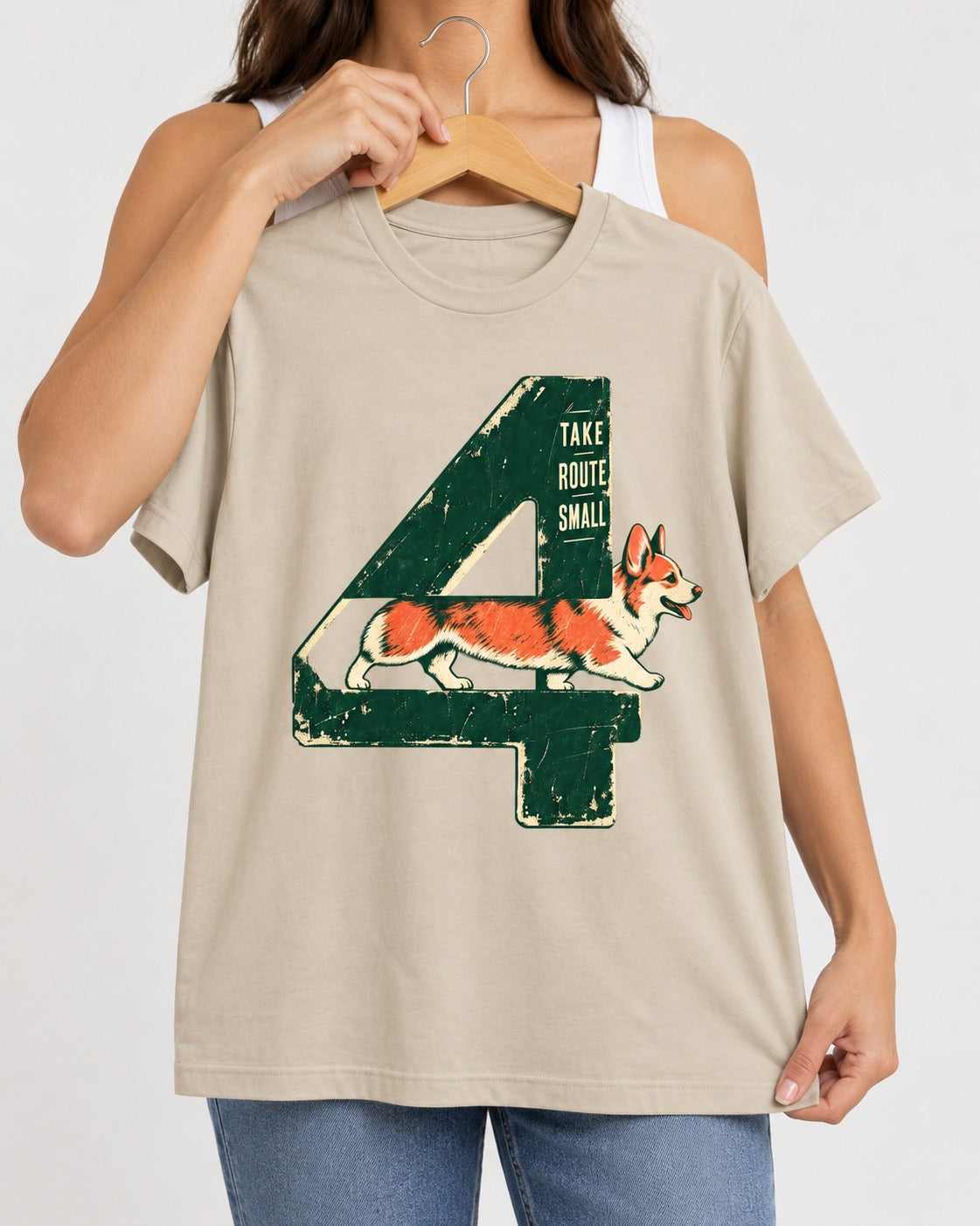 Take Route Small Corgi T-Shirt in Sand, held up on a hanger