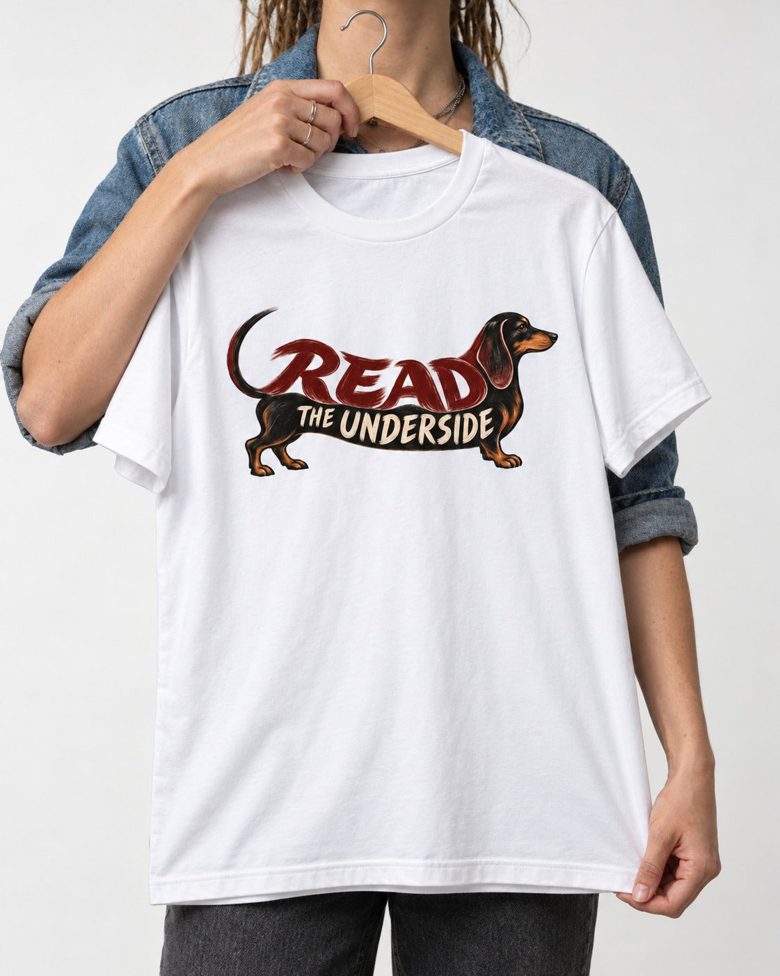 Dachshund Read The Underside Body Lettering Graphic T-Shirt in White, held up on a hanger