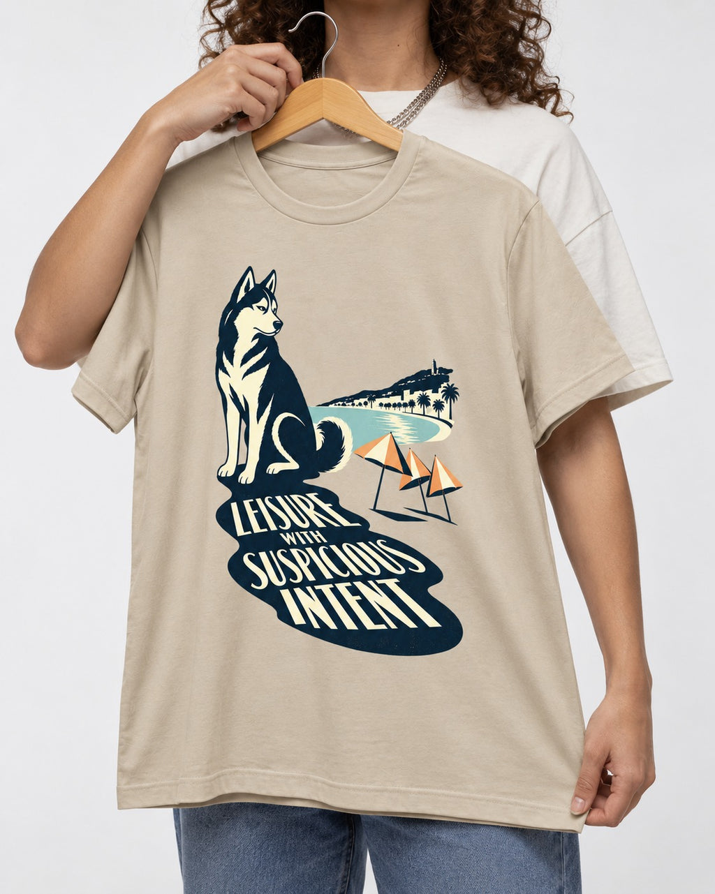 Husky Leisure with Suspicious Intent T-Shirt in Sand, held up on a hanger