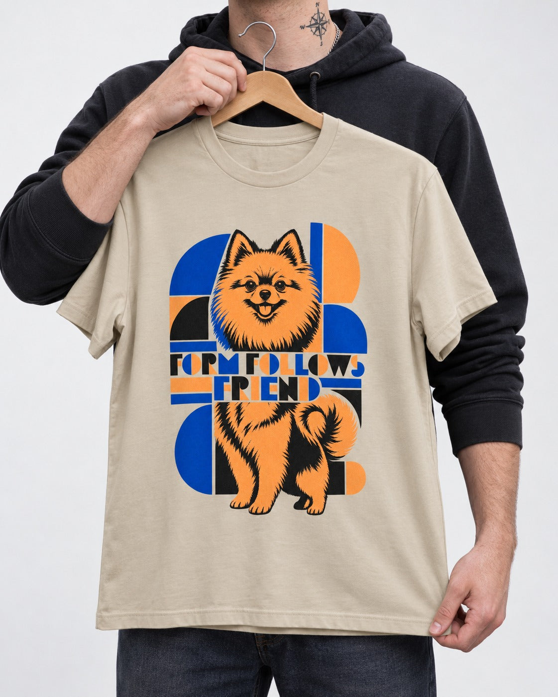 Form Follows Pomeranian Friend T-Shirt in Sand, held up on a hanger