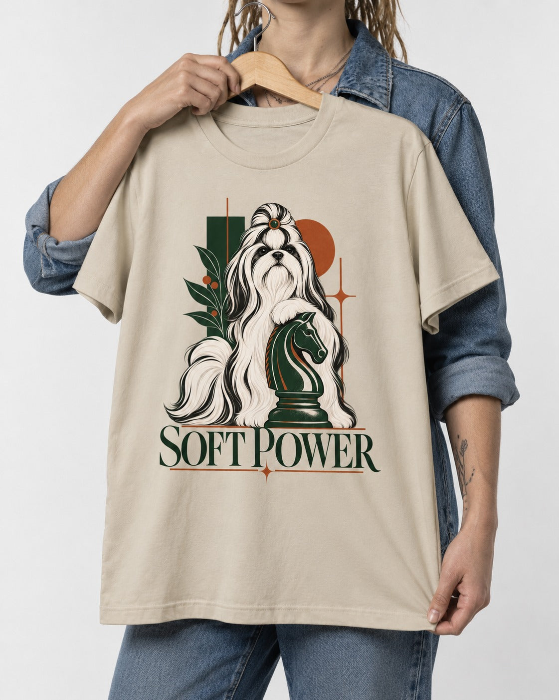 Soft Power Shih Tzu T-Shirt in Sand, held up on a hanger