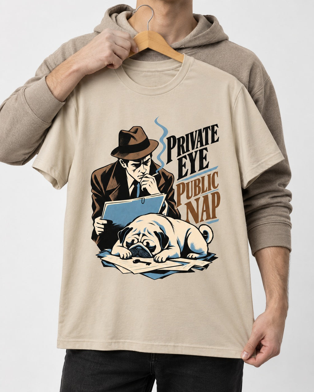 Pug Private Eye Public Nap T-Shirt in Sand, held up on a hanger
