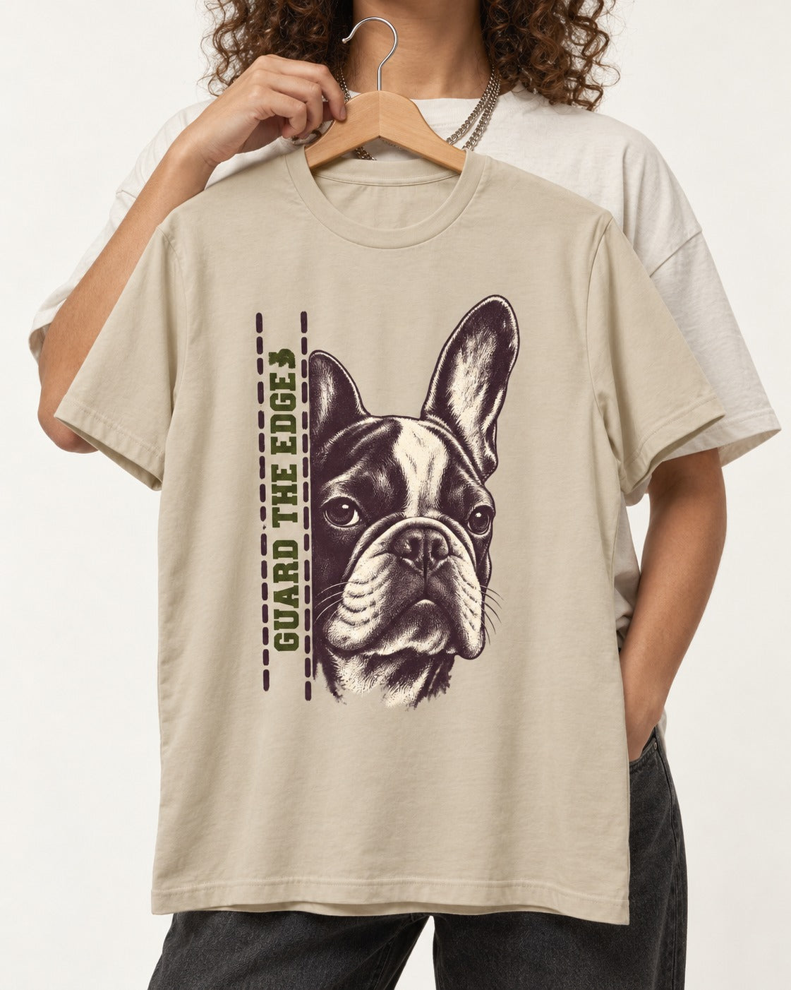 Frenchie Guard the Edge T-Shirt in Sand, held up on a hanger