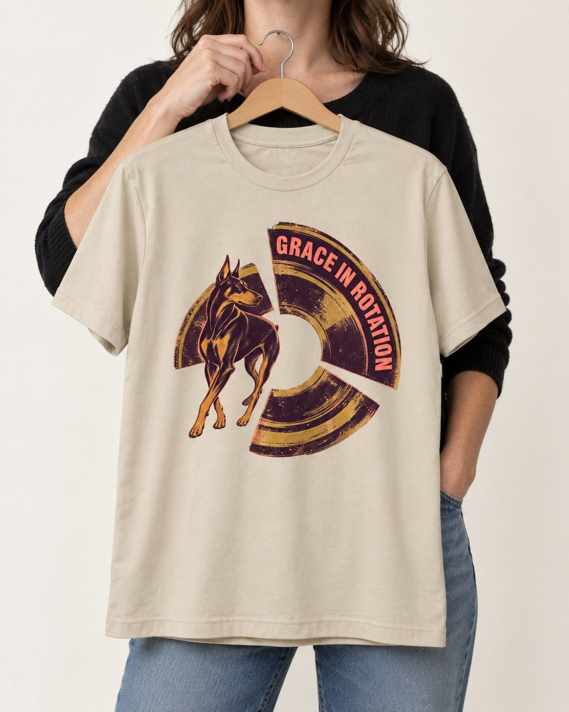 Doberman Grace in Rotation T-Shirt in Sand, held up on a hanger