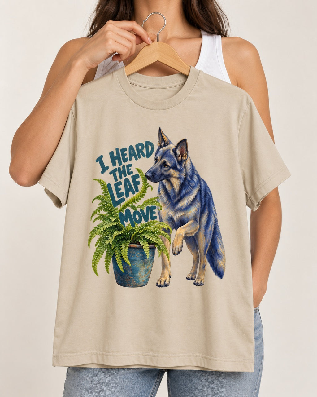 German Shepherd Dog Heard the Leaf Move T-Shirt in Sand, held up on a hanger