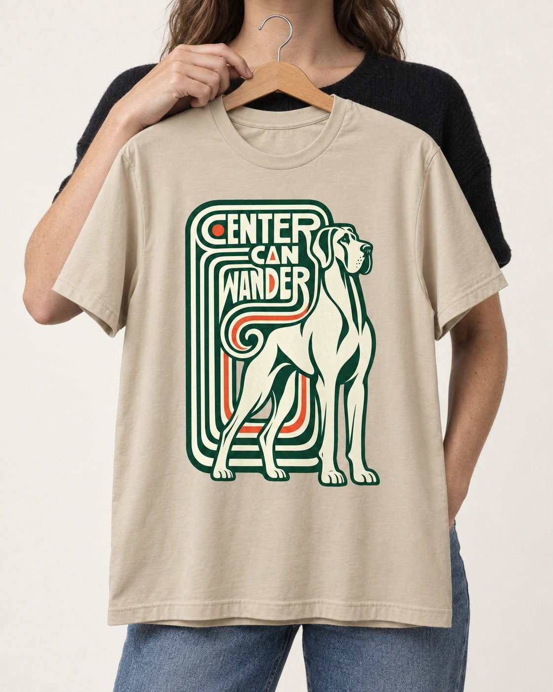 Great Dane Center Can Wander T-Shirt in Sand, held up on a hanger