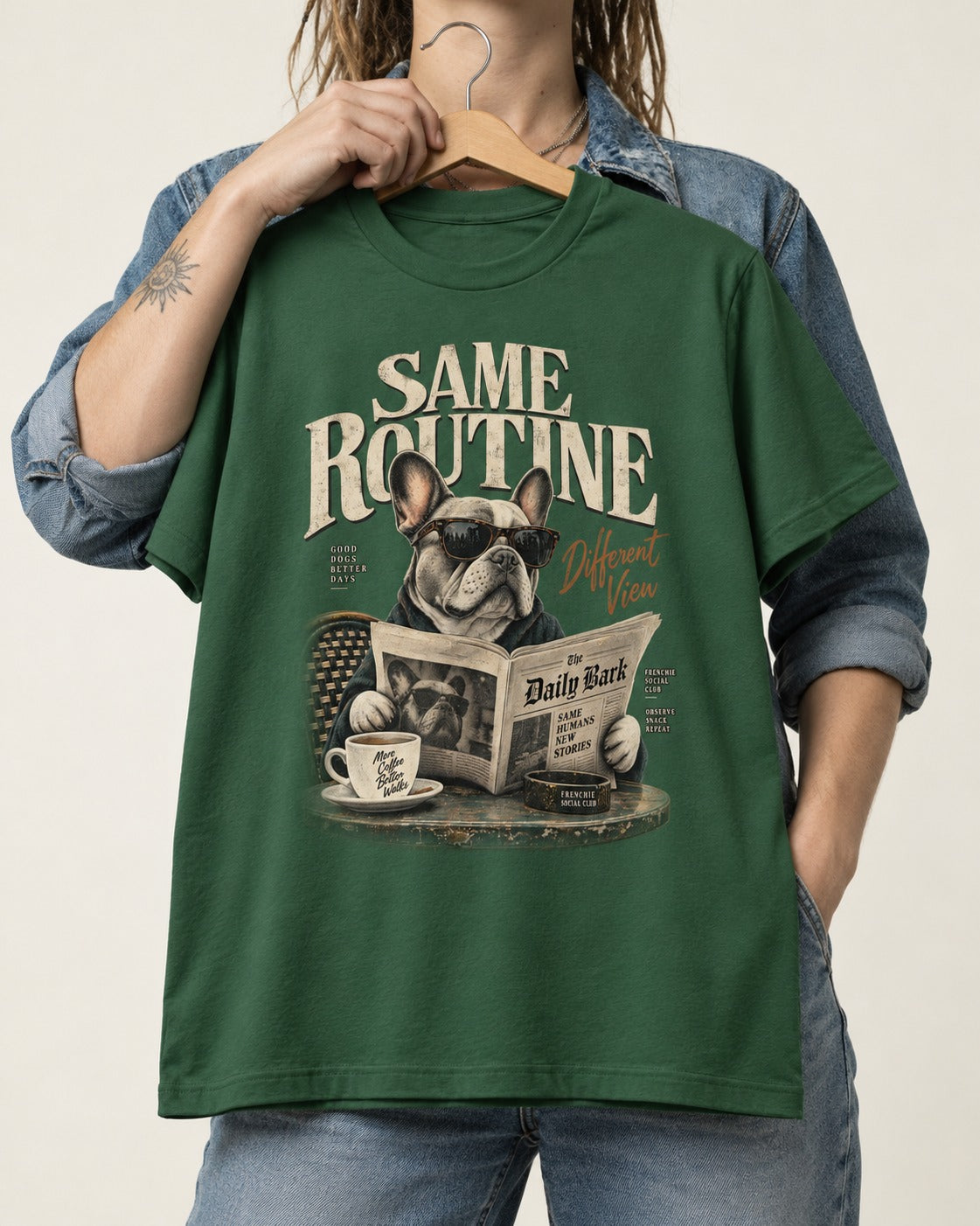 Frenchie Same Routine Different View Graphic T-Shirt in Forest Green, held up on a hanger