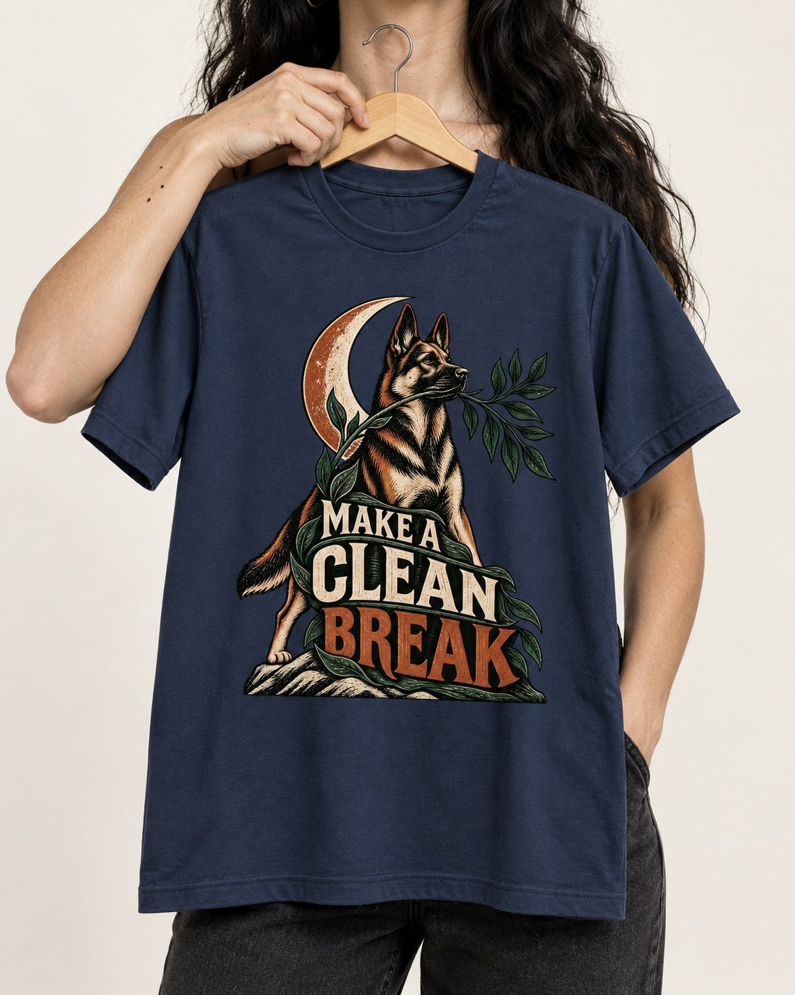 Make A Clean Break Crescent Botanical German Shepherd Dog Graphic T-Shirt in Navy, held up on a hanger