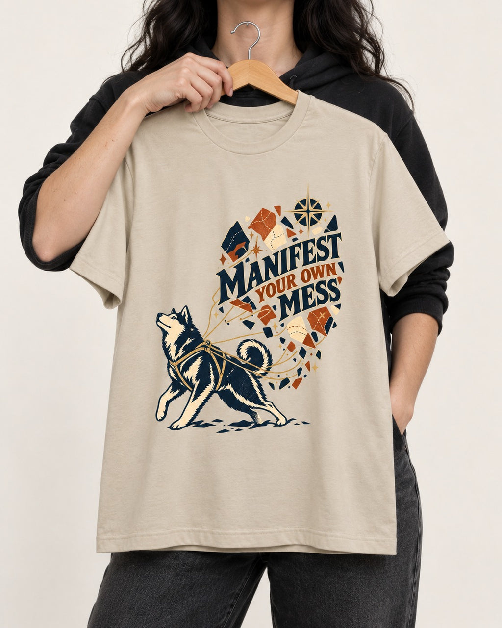 Husky Manifest Your Own Mess T-Shirt in Sand, held up on a hanger