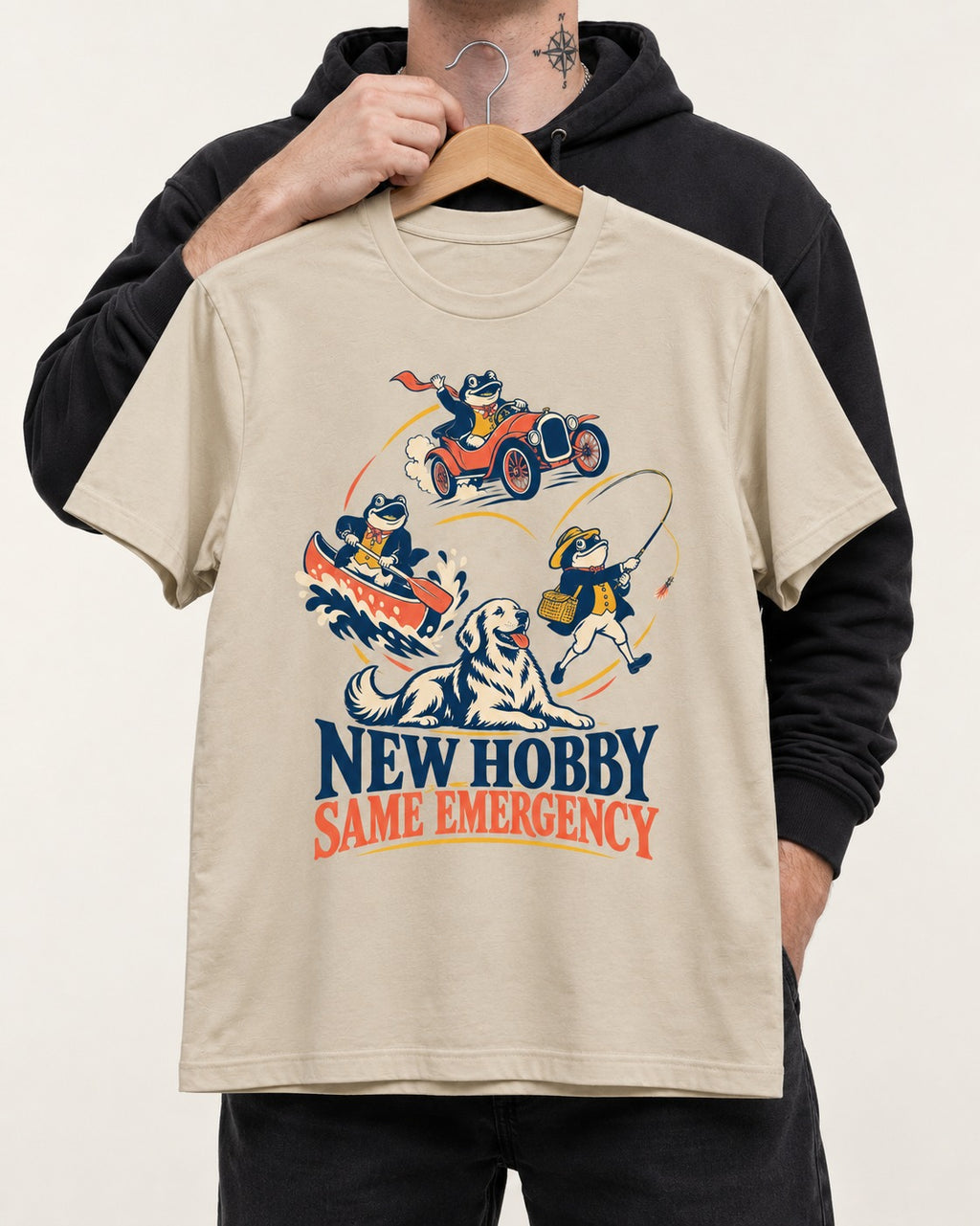 Golden Retriever New Hobby Same Emergency T-Shirt in Sand, held up on a hanger