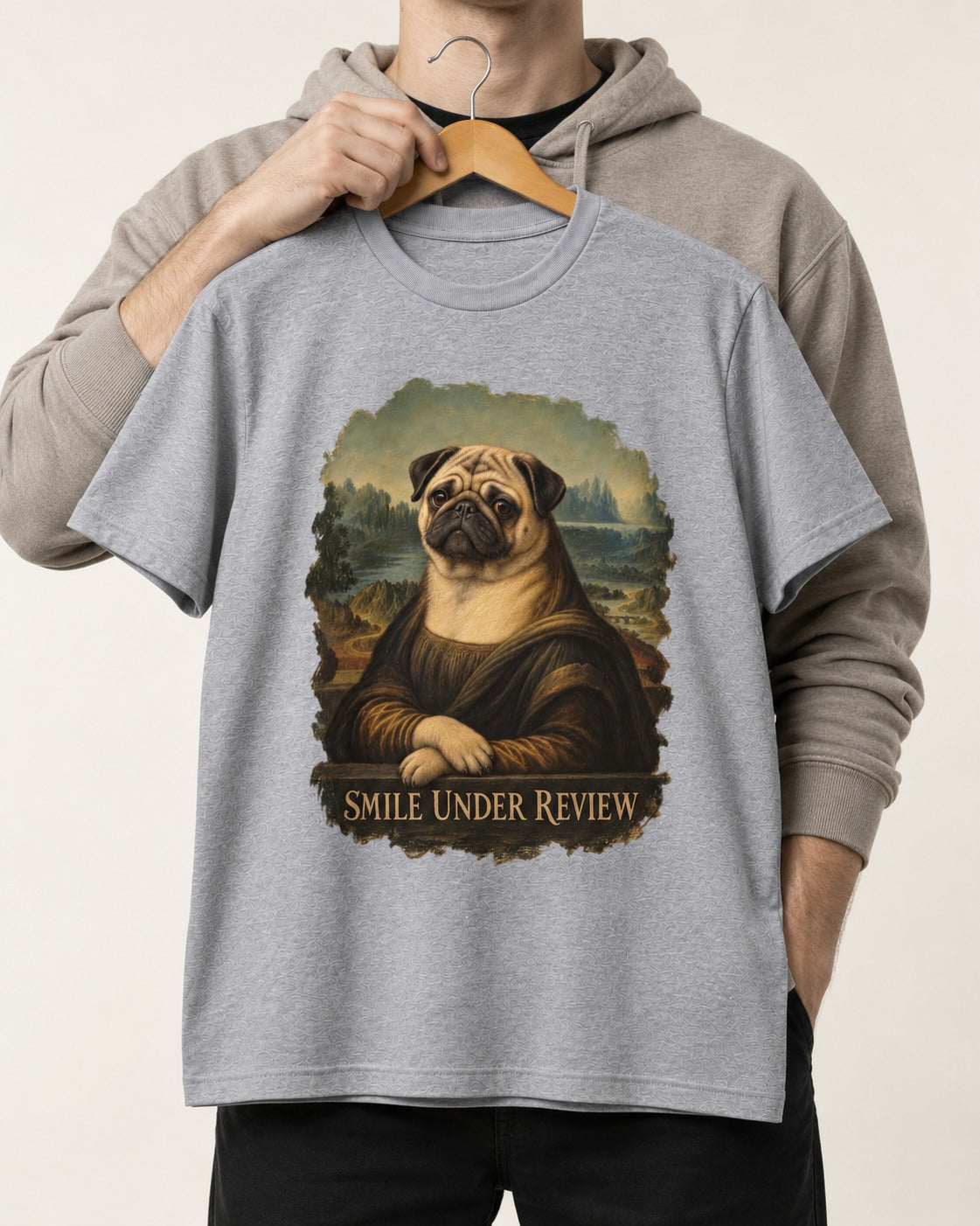 Pug Smile Under Review Mona Lisa Graphic T-Shirt in Sport Grey, held up on a hanger
