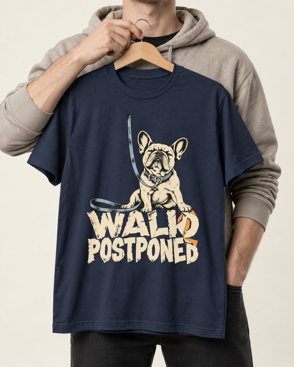 Frenchie Walk Postponed Leash Graphic T-Shirt in Navy, held up on a hanger