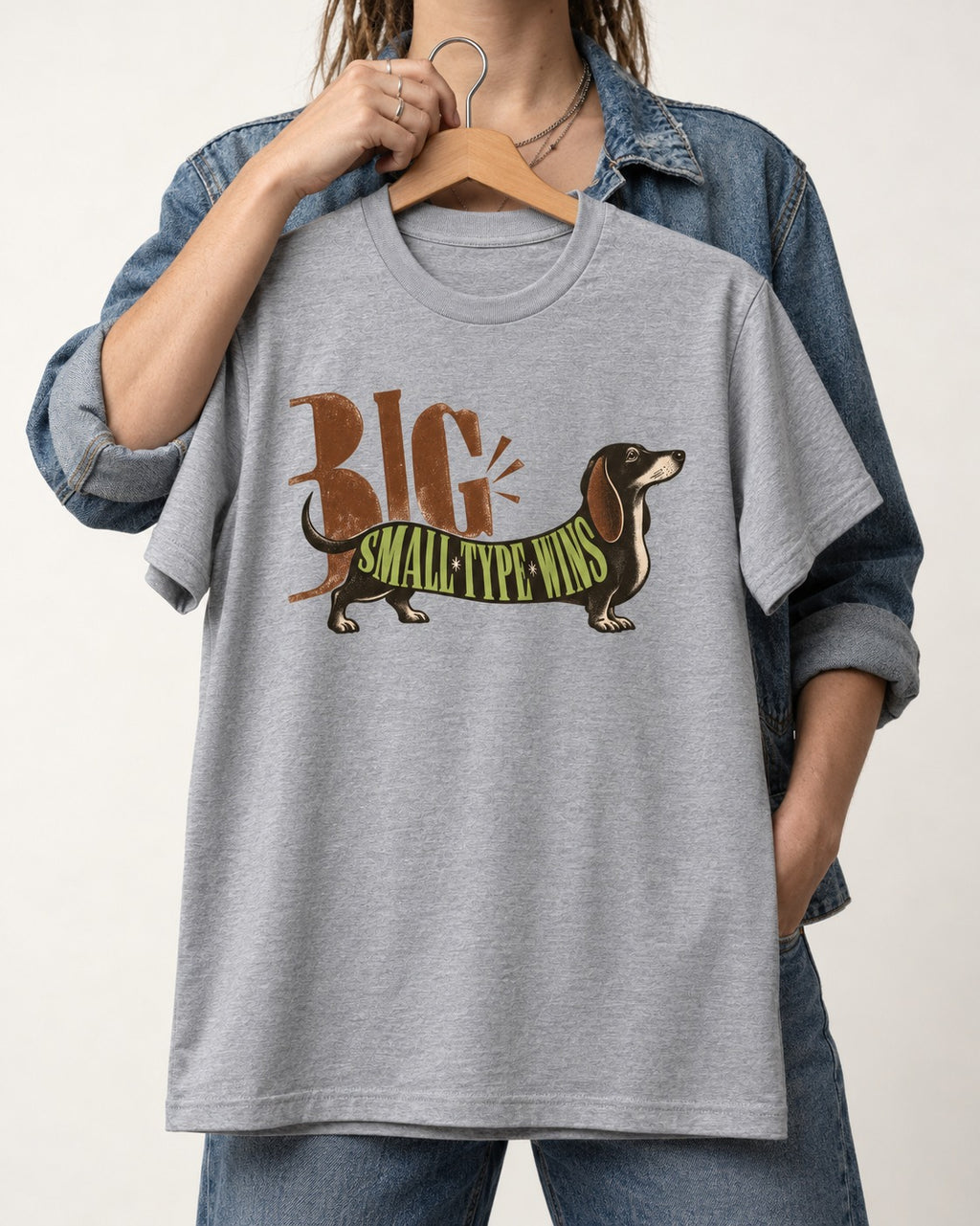 Dachshund Small Type Wins T-Shirt in Sport Grey, held up on a hanger