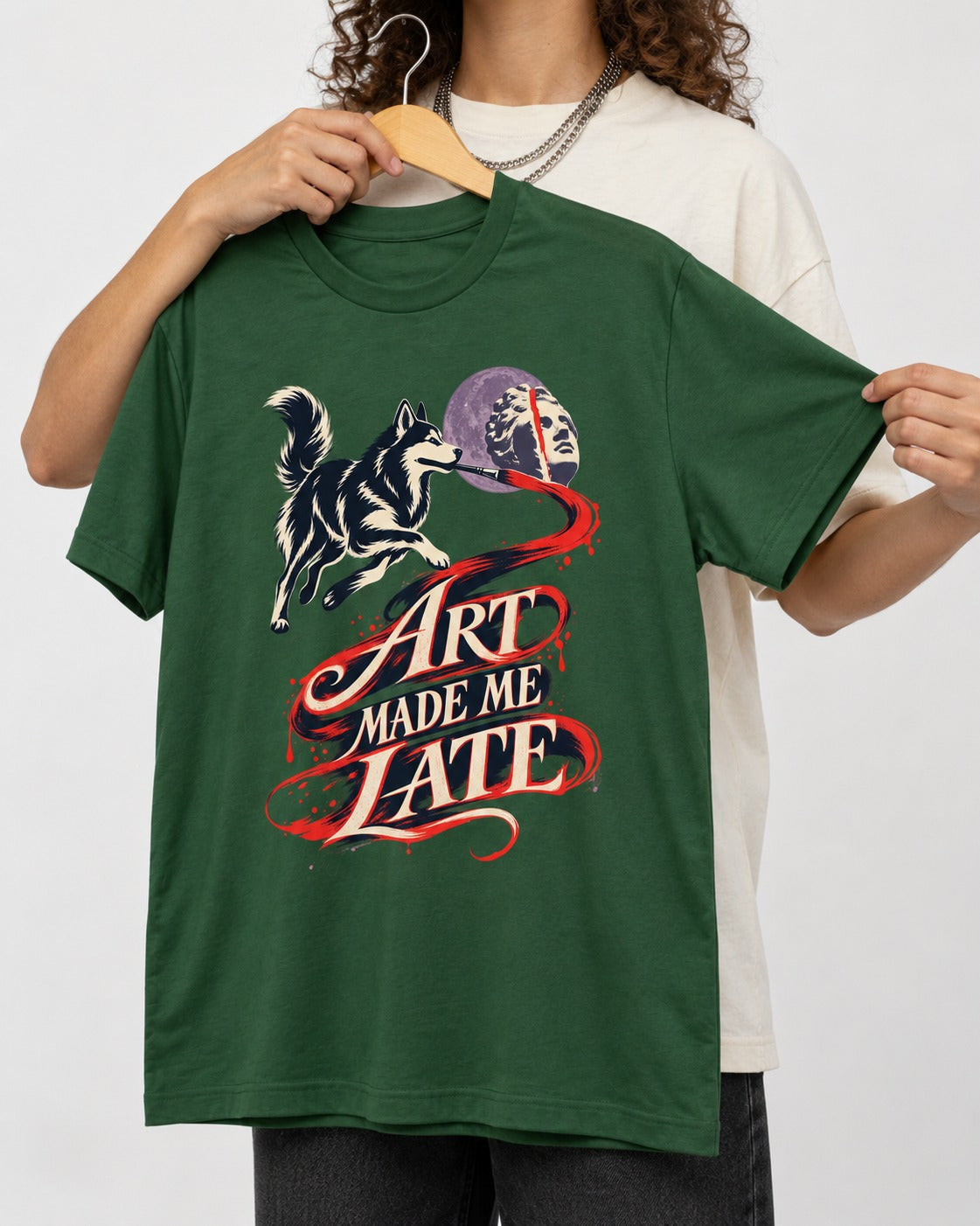 Husky Art Made Me Late Paintbrush Graphic T-Shirt in Forest Green, held up on a hanger