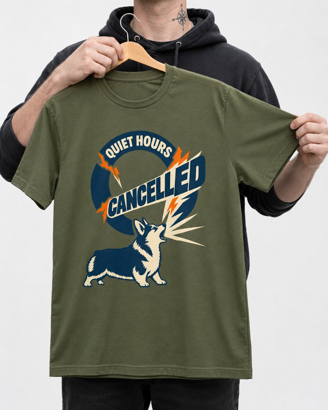 Corgi Quiet Hours Cancelled Calling Badge Graphic T-Shirt in Heather Military Green, held up on a hanger