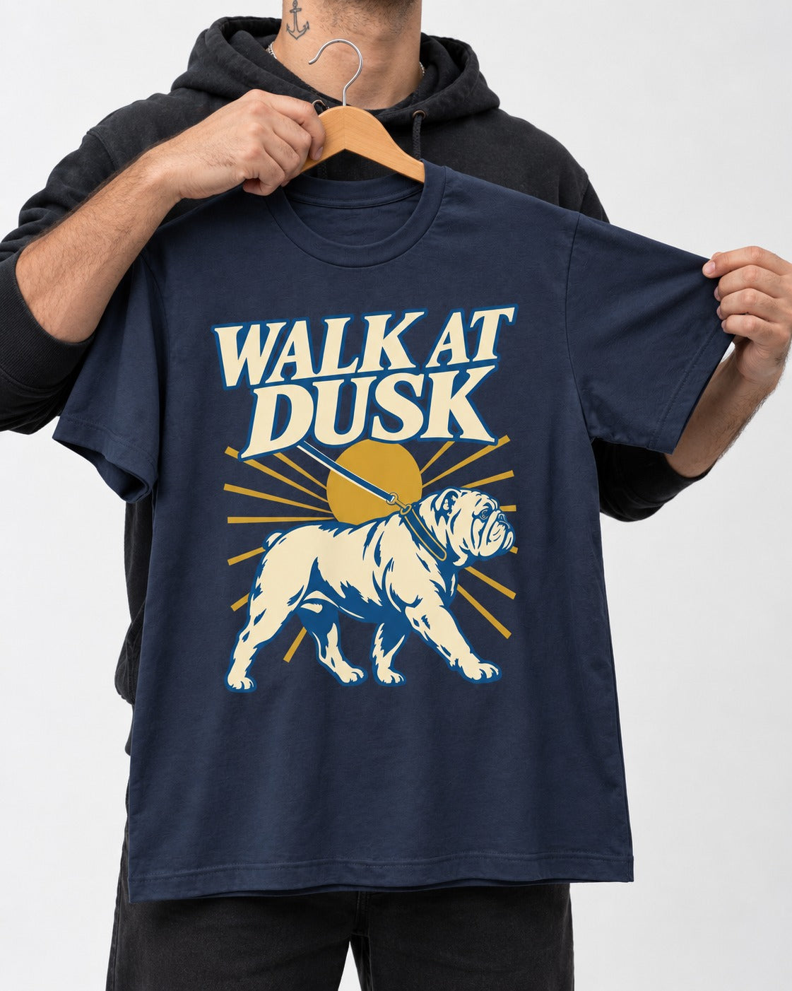 English Bulldog Walk at Dusk Sunset Graphic T-Shirt in Navy, held up on a hanger