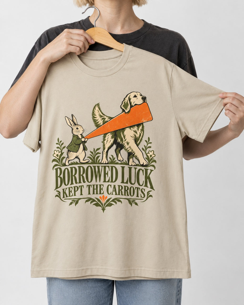 Borrowed Luck Golden Retriever T-Shirt in Sand, held up on a hanger