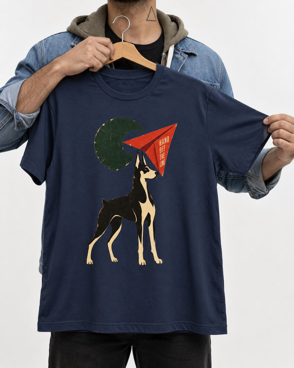 Doberman Hand Off the Line Paper Plane Graphic T-Shirt in Navy, held up on a hanger
